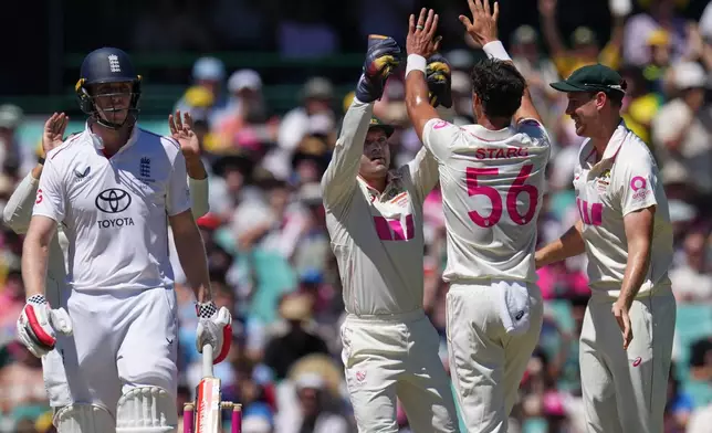 England's Zak Crawley, left, reacts after he was dismissed by Australia's Mitchell Starc, second right, during play on day four of the fifth and final Ashes cricket test between England and Australia in Sydney, Wednesday, Jan. 7, 2026. (AP Photo/Mark Baker)