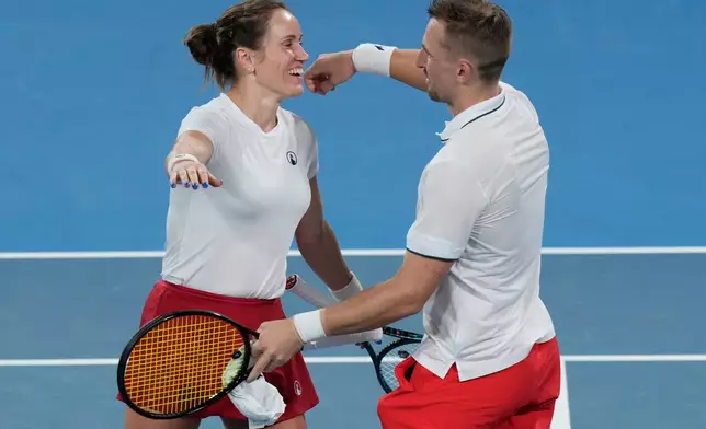 Katarzyna Kawa, left, and Jan Ziellinski of Poland celebrate their win over Storm Hunter and John-Patrick Smith of Australia during their quarterfinal doubles match at the United Cup tennis tournament in Sydney, Friday, Jan. 9, 2026. (AP Photo/Rick Rycroft)