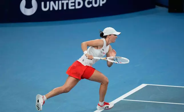 Iga Swiatek of Poland runs to play a shot to Maya Joint of Australia during their quarterfinal match at the United Cup tennis tournament in Sydney, Friday, Jan. 9, 2026. (AP Photo/Rick Rycroft)