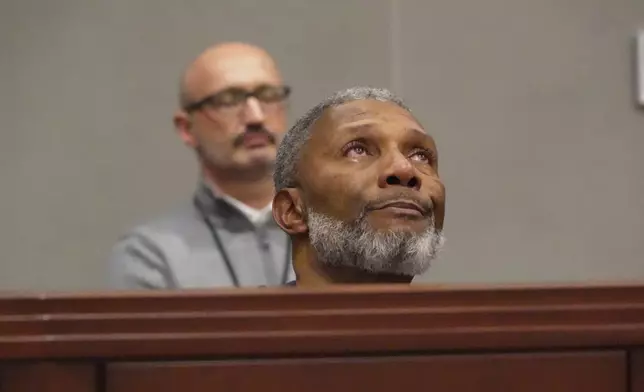 Tears well in Tracey Howard's eyes as he hears a prosecutor describe his wife Nicole Connors' murder during a hearing in Wake County Superior Court on Wednesday, Jan. 21, 2026, in Raleigh, N.C. (AP Photo/Allen G. Breed)