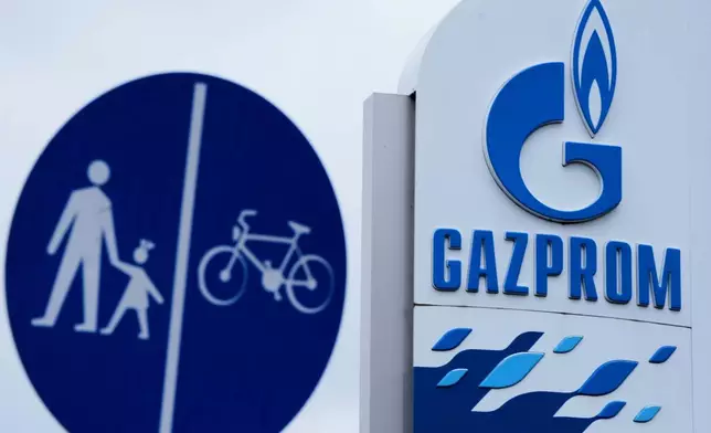 The Gazprom company logo at a petrol station and a traffic sign are seen in Belgrade, Serbia, Sunday, Nov. 23, 2025. (AP Photo/Darko Vojinovic)