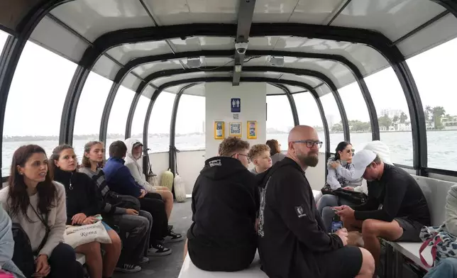 Passengers ride the Miami Beach Water Taxi from Miami Beach to the city of Miami, Wednesday, Jan. 21, 2026. (AP Photo/Marta Lavandier)