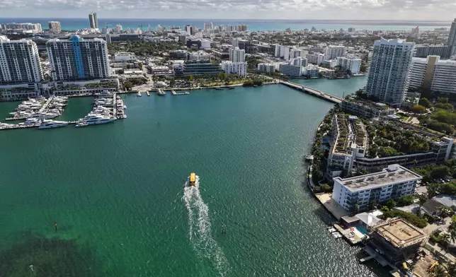 The Miami Beach Water Taxi glides along Biscayne Bay towards Miami Beach, Fla., Tuesday, Jan. 20, 2026. (AP Photo/Daniel Kozin)