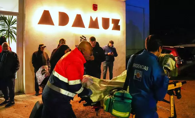 An injured person is transported to the makeshift hospital in the sports center in Adamuz, near Córdoba, southern Spain, Monday, Jan. 19, 2026, after a high-speed train derailed and collided with another train. (Francisco J. Olmo/Europa Press via AP)
