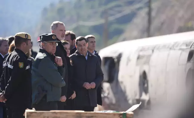 Spain's King Felipe VI and Queen Letizia visit the site of a train collision in Adamuz, southern Spain, Tuesday, Jan. 20, 2026. (Joaquin Corchero/Europa Press via AP) **SPAIN OUT**