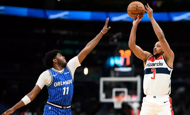 Washington Wizards guard CJ McCollum (3) shoots against Orlando Magic guard Jase Richardson (11) Washington Wizards guard CJ McCollum (3) during the first half of an NBA basketball game, Tuesday, Jan. 6, 2026, in Washington. (AP Photo/Nick Wass)