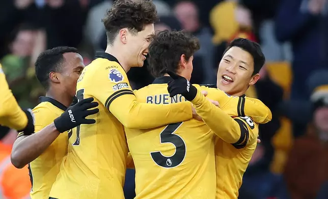 Wolverhampton Wanderers' Hwang Hee-Chan, right, celebrates after scoring his side's second goal during the English Premier League soccer match between Wolverhampton Wanderers and West Ham United in Wolverhampton, England, Saturday, Jan. 3, 2026. (Nigel French/PA via AP)