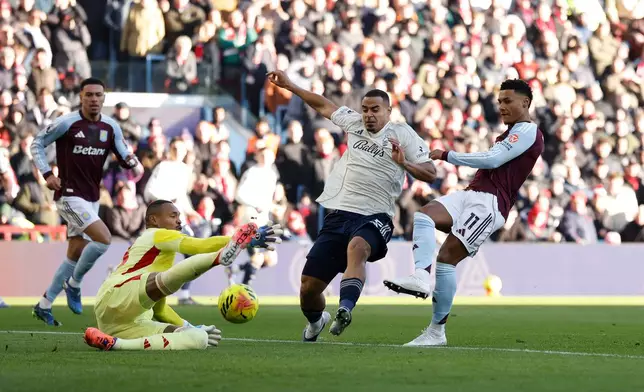 Aston Villa's Ollie Watkins, right, has a shot saved by Nottingham Forest goalkeeper John Victor during their English Premier League soccer match in Birmingham, England, Saturday, Jan. 3, 2026. (Cody Froggatt/PA via AP)
