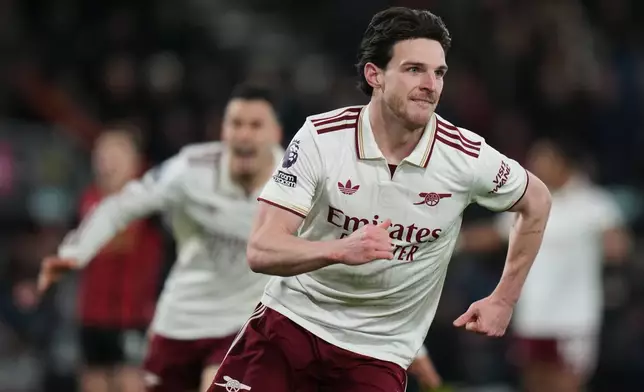 Arsenal's Declan Rice celebrates after scoring his sides second goal during the English Premier League soccer match between Bournemouth and Arsenal in Bournemouth, England, Saturday, Jan. 3, 2026. (AP Photo/Alastair Grant)