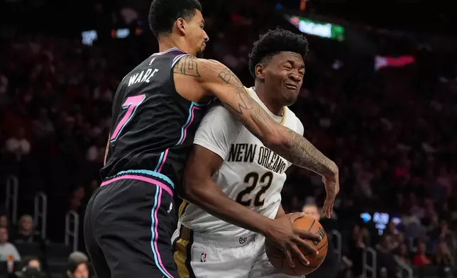 New Orleans Pelicans center Derik Queen (22) clashes with Miami Heat center Kel'el Ware (7) during the first half of an NBA basketball game, Sunday, Jan. 4, 2026, in Miami. (AP Photo/Rebecca Blackwell)