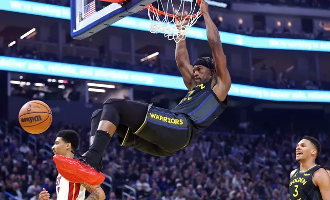 Golden State Warriors' Jimmy Butler III dunks in the first half of an NBA basketball game against Miami Heat in San Francisco on Monday, Jan. 19, 2026. (Scott Strazzante/San Francisco Chronicle via AP)
