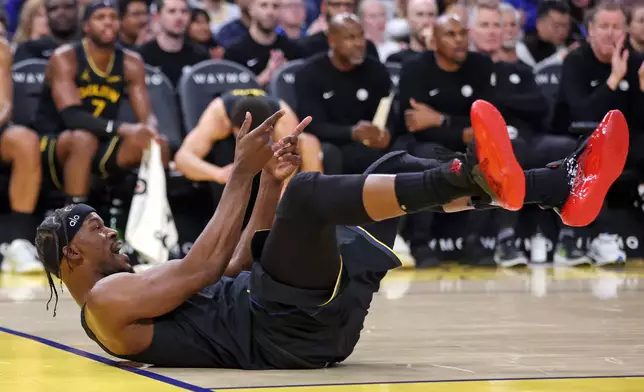 Golden State Warriors' Jimmy Butler III reacts to a basket and a foul in the first half of an NBA basketball game against Miami Heat in San Francisco on Monday, Jan. 19, 2026. (Scott Strazzante/San Francisco Chronicle via AP)