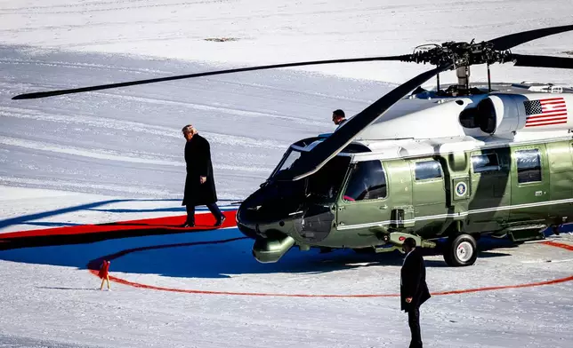 US President Donald Trump walks out of the Marine One helicopter as he arrives for the 56th annual meeting of the World Economic Forum, WEF, in Davos, Switzerland, Wednesday, Jan. 21, 2026. (Michael Buholzer/Keystone via AP)