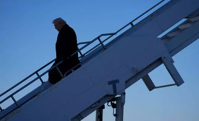 President Donald Trump steps off Air Force One at Des Moines International Airport in Des Moines, Iowa, Tuesday, Jan. 27, 2026. (AP Photo/Mark Schiefelbein)