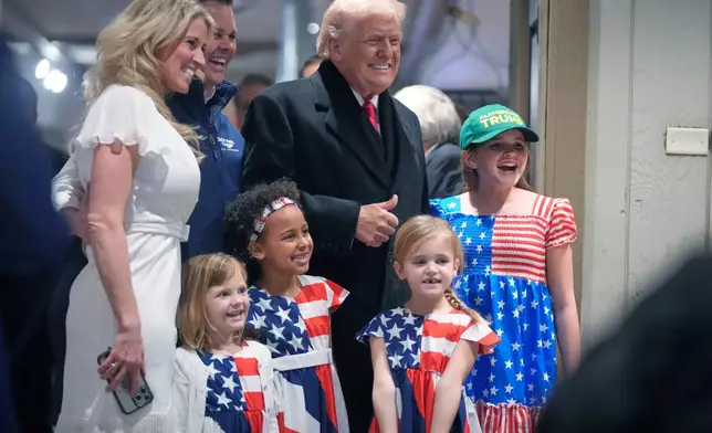 President Donald Trump smiles as he poses for pictures during a visit to a restaurant in Urbandale, Iowa, Tuesday, Jan. 27, 2026. (AP Photo/Mark Schiefelbein)