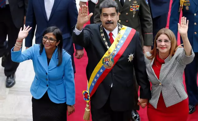 FILE - Venezuela's President Nicolas Maduro, then Constituent National Assembly President Delcy Rodriguez, left, and first lady Cilia Flores, wave as they arrive to the National Assembly, in Caracas, Venezuela, May 24, 2018. (AP Photo/Ariana Cubillos, File)