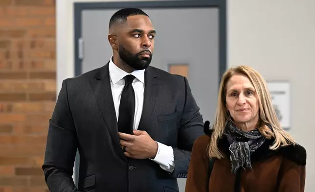 Former Michigan football coach Sherrone Moore, left, stands with his attorney, Ellen K. Michaels, in the lobby of the courthouse, Thursday, Jan. 22, 2026, in Ann Arbor, Mich. (AP Photo/Jose Juarez)