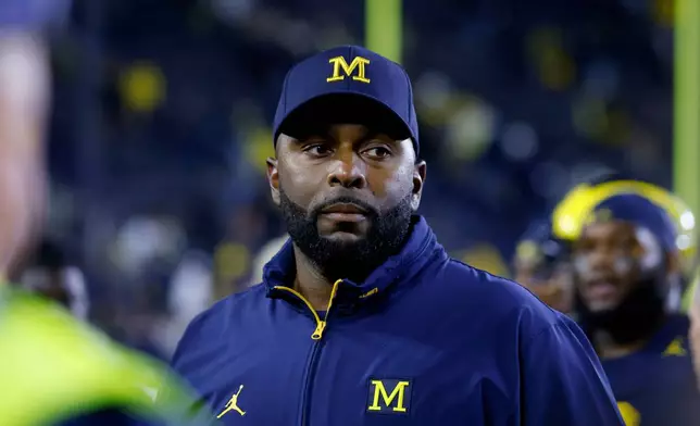FILE - Michigan coach Sherrone Moore walks off the field following an NCAA football game Aug. 30, 2025, in Ann Arbor, Mich. (AP Photo/Al Goldis, File)