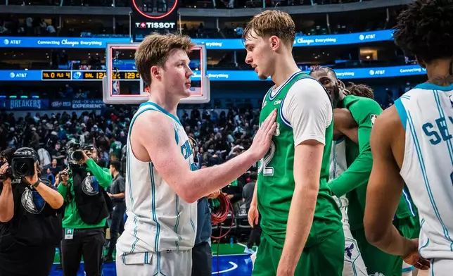 Dallas Mavericks forward Cooper Flagg, right, and Charlotte Hornets guard Kon Knueppel, left, talk after an NBA basketball game, Thursday, Jan. 29, 2026, in Dallas. (AP Photo/Jessica Tobias)