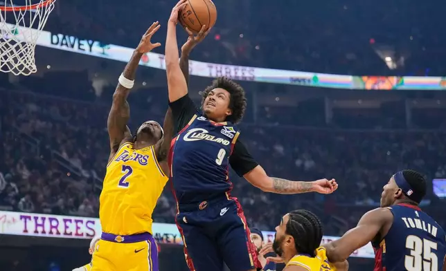 Los Angeles Lakers forward Jarred Vanderbilt (2) and Los Angeles Lakers guard Bronny James (9) reach for a rebound in the first half of an NBA basketball game in Cleveland, Wednesday, Jan. 28, 2026. (AP Photo/Sue Ogrocki)