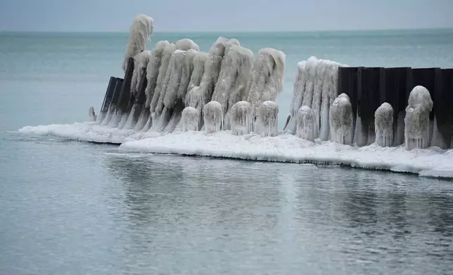 Ice forms on a pier along Lake Michigan ona. cold Wednesday, Jan. 21, 2026, in Chicago. (AP Photo/Erin Hooley)