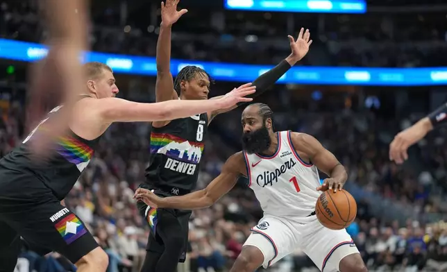 Los Angeles Clippers guard James Harden, right, looks to pass the ball under defensive pressure from Denver Nuggets center Nikola Jokić, left, and guard Peyton Watson in the second half of an NBA basketball game Friday, Jan. 30, 2026, in Denver. (AP Photo/David Zalubowski)