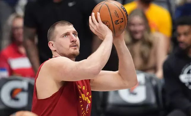 Denver Nuggets center Nikola Jokić warms up before an NBA basketball game against the Los Angeles Clippers, Friday, Jan. 30, 2026, in Denver. (AP Photo/David Zalubowski)