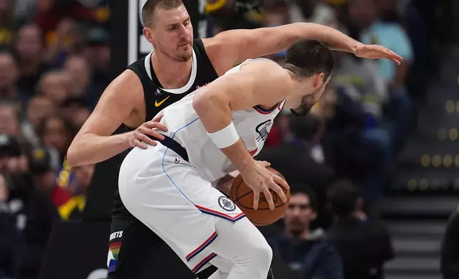 Los Angeles Clippers center Ivica Zubac, front, is covered by Denver Nuggets center Nikola Jokić, back, in the first half of an NBA basketball game Friday, Jan. 30, 2026, in Denver. (AP Photo/David Zalubowski)