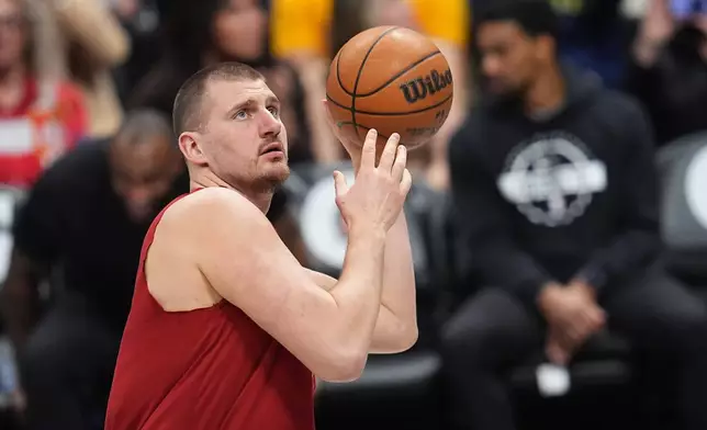 Denver Nuggets center Nikola Jokić warms up before an NBA basketball game against the Los Angeles Clippers, Friday, Jan. 30, 2026, in Denver. (AP Photo/David Zalubowski)