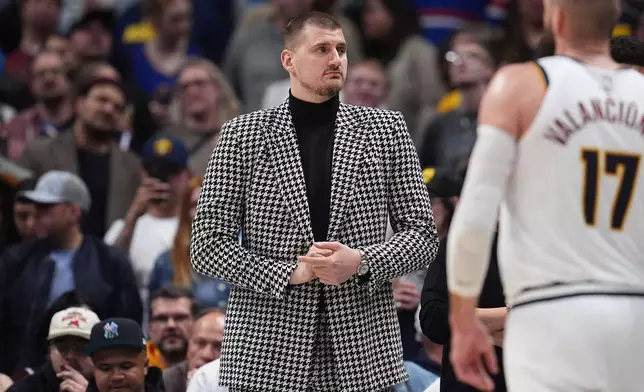 Injured Denver Nuggets center Nikola Jokić looks on from the baseline in the second half of an NBA basketball game against the Brooklyn Nets Thursday, Jan. 29, 2026, in Denver. (AP Photo/David Zalubowski)