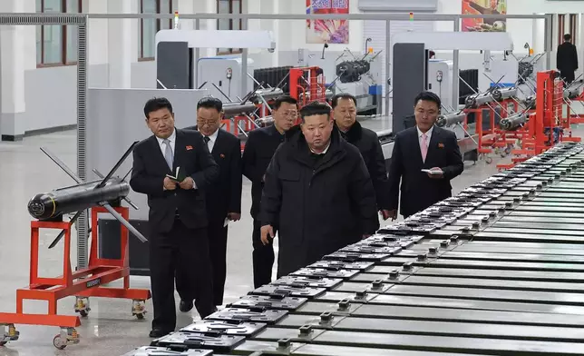 In this photo provided by the North Korean government, its leader Kim Jong Un, front right, visits a major munitions factory at an undisclosed place in North Korea Saturday, Jan. 3, 2026. Independent journalists were not given access to cover the event depicted in this image distributed by the North Korean government. The content of this image is as provided and cannot be independently verified. (Korean Central News Agency/Korea News Service via AP)