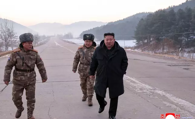 In this photo provided by the North Korean government, leader Kim Jong Un walks on a road as he inspects test-flights of hypersonic missiles, in Pyongyang, North Korea, Sunday, Jan. 4, 2026. Independent journalists were not given access to cover the event depicted in this image distributed by the North Korean government. The content of this image is as provided and cannot be independently verified. Korean language watermark on image as provided by source reads: "KCNA" which is the abbreviation for Korean Central News Agency. (Korean Central News Agency/Korea News Service via AP)