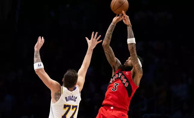 Toronto Raptors forward Brandon Ingram (3) shoots over Los Angeles Lakers guard Luka Doncic (77) during the first half of an NBA basketball game in Los Angeles, Sunday, Jan. 18, 2026. (AP Photo/Kyusung Gong)