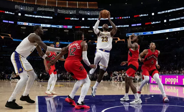 Los Angeles Lakers forward LeBron James (23) goes up for a basket during the first half of an NBA basketball game against the Toronto Raptors in Los Angeles, Sunday, Jan. 18, 2026. (AP Photo/Kyusung Gong)