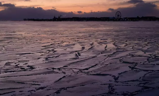 Ice forms along the shore of Lake Michigan, Friday, Jan. 23, 2026, in Chicago. (AP Photo/Kiichiro Sato)