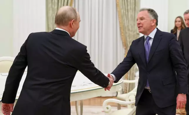 Russian President Vladimir Putin, left, greets U.S. President Donald Trump's envoys Steve Witkoff at the Senate Palace of the Kremlin, in Moscow, Thursday, Jan. 22, 2026. (Alexander Kazakov/Sputnik, Kremlin Pool Photo via AP)