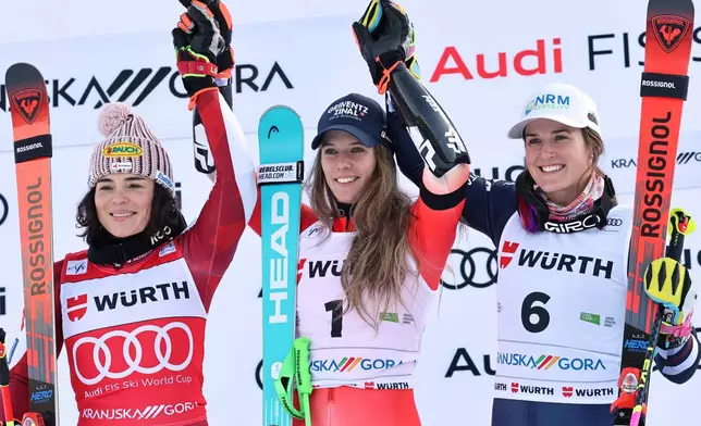 Switzerland's Camille Rast, center, winner of an alpine ski, women's World Cup giant slalom, poses on the podium with second placed Austria's Julia Scheib, left, and third placed United States' Paula Moltzan in Kranjska Gora, Slovenia, Saturday, Jan. 3, 2026. (AP Photo/Marco Trovati)