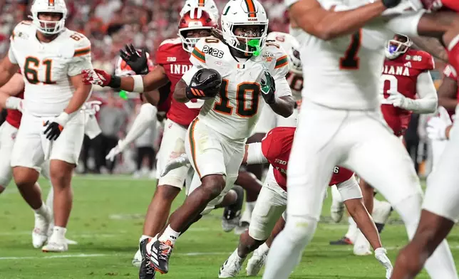 Miami wide receiver Malachi Toney scores against Indiana during the second half of the College Football Playoff national championship game, Monday, Jan. 19, 2026, in Miami Gardens, Fla. (AP Photo/Rebecca Blackwell)