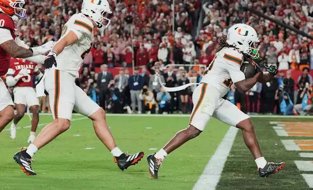 Miami wide receiver Malachi Toney scores against Indiana during the second half of the College Football Playoff national championship game, Monday, Jan. 19, 2026, in Miami Gardens, Fla. (AP Photo/Rebecca Blackwell)