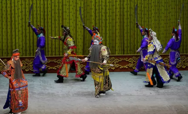 Peking Opera actors perform during a show at Jixiang Theatre in Beijing, China, Sunday, Sept. 7, 2025. (AP Photo/Mahesh Kumar A.)