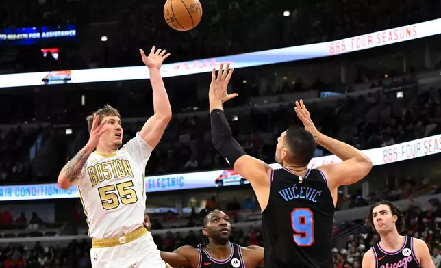 Boston Celtics guard Baylor Scheierman (55) shoots against Chicago Bulls center Nikola Vucevic (9) during the first half of an NBA basketball game Monday, Jan. 24, 2026, in Chicago. (AP Photo/Matt Marton)