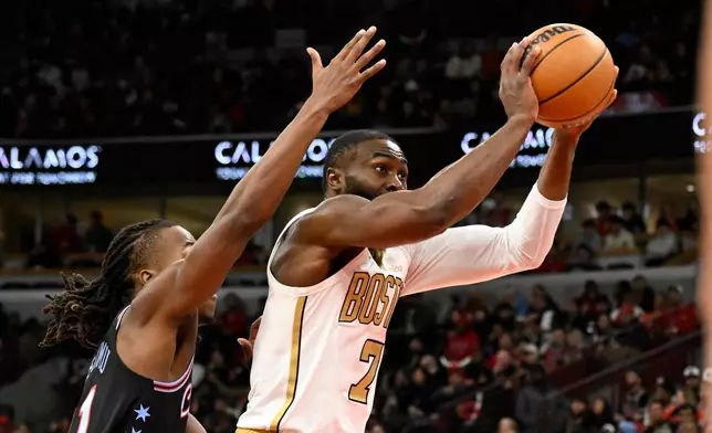 Boston Celtics guard Jaylen Brown (7) shoots against Chicago Bulls guard Ayo Dosunmu during the first half of an NBA basketball game Monday, Jan. 24, 2026, in Chicago. (AP Photo/Matt Marton)