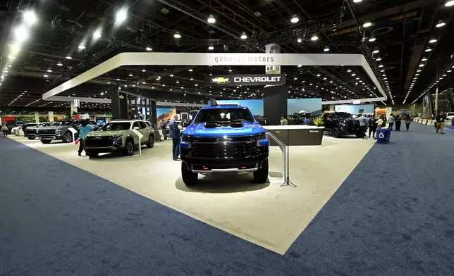 FILE - The General Motors display is seen, which includes a 2025 Silverado ZR2, foreground, at the Detroit Auto Show, Friday, Jan. 10, 2025, in Detroit. (AP Photo/Jose Juarez, file)