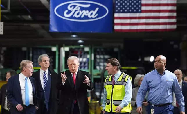 President Donald Trump speaks to, from left Bill Ford, Executive Chairman of Ford, Treasury Secretary Scott Bessent, Jim Farley, CEO of Ford, and Corey Williams, Ford River Rouge Plant Manager, during a tour of the Ford River Rogue complex, Tuesday, Jan. 13, 2026, in Dearborn, Mich. (AP Photo/Evan Vucci)