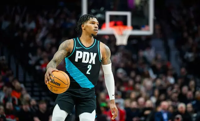 Portland Trail Blazers guard Caleb Love dribbles downccourt during the first half of an NBA basketball game against the Utah Jazz, Monday, Jan. 5, 2026, in Portland, Ore. (AP Photo/Molly J. Smith)