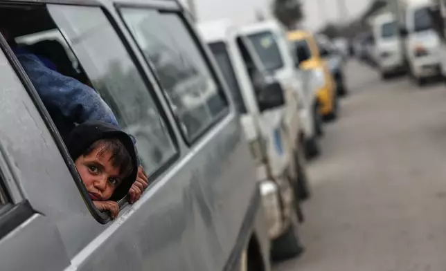People cross a damaged bridge over the Euphrates River in Deir Ezzor, eastern Syria, after Syrian government forces took control of the area following the withdrawal of Kurdish-led Syrian Democratic Forces (SDF), Thursday, Jan. 22, 2026. (AP Photo/Ghaith Alsayed)