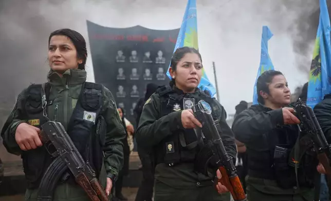 Female soldiers of the Kurdish-led, U.S.-backed Syrian Democratic Forces (SDF) march during a military parade in Qamishli, northeastern Syria, Sunday, Jan. 18, 2026. Syrian government forces have seized a strategic towns in eastern Syria, intensifying their push against Kurdish-led forces east of the Euphrates River.(AP Photo/Baderkhan Ahmad)