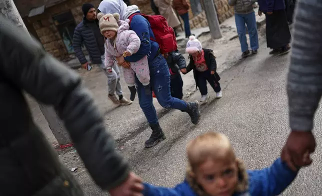 FILE - Displaced residents return to the Sheikh Maqsoud neighborhood after days of fighting between government forces and Kurdish fighters in the northern city of Aleppo, Syria, Tuesday, Jan. 13, 2026. (AP Photo/Ghaith Alsayed)