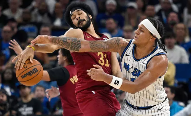 Orlando Magic forward Paolo Banchero (5) is fouled by Cleveland Cavaliers center Jarrett Allen (31) during the second half of an NBA basketball game, Saturday, Jan. 24, 2026, in Orlando, Fla. (AP Photo/Phelan M. Ebenhack)