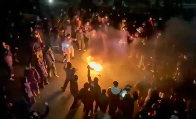 FILE - In this frame grab from footage circulating on social media shows protesters dancing and cheering around a bonfire as they take to the streets despite an intensifying crackdown as the Islamic Republic remains cut off from the rest of the world, in Tehran, Iran, Jan. 9, 2026.(UGC via AP, File)
